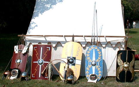 From left to right, shields: early Republican style, early 1st Cent. type with Legio X Fretensis markings, two later Republican patterns, and an ornate officer's scutum.  Helmets:  Republican, 1st Cent. AD, and 1st Cent. Centurion's helmet with plume
